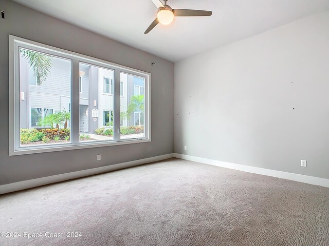 spare room featuring carpet and ceiling fan