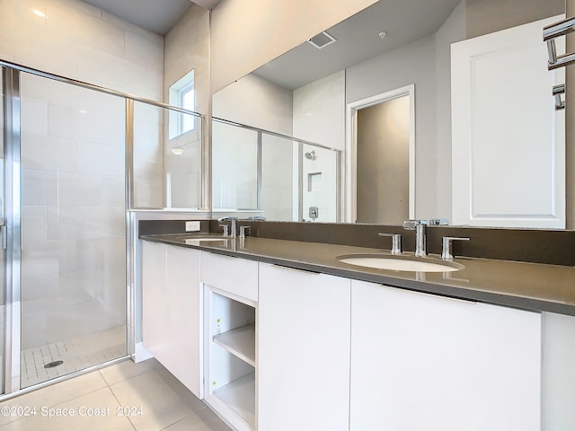 bathroom with vanity, an enclosed shower, and tile patterned flooring