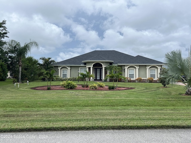 ranch-style house with a front yard and french doors