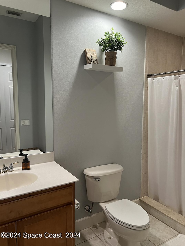 bathroom with vanity, a shower with shower curtain, tile patterned floors, and toilet