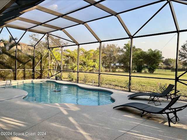 view of pool featuring a patio area and glass enclosure