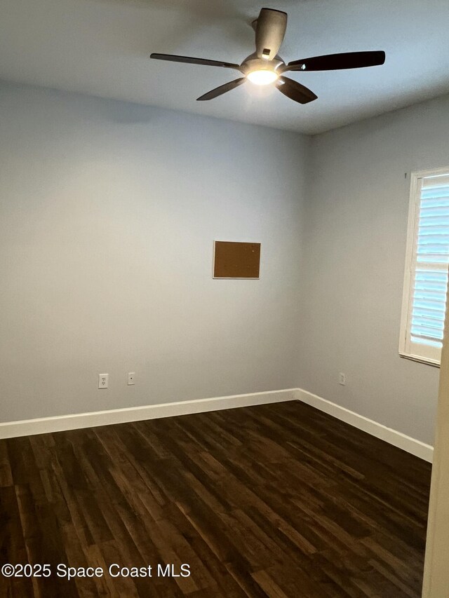 empty room with dark hardwood / wood-style flooring and ceiling fan