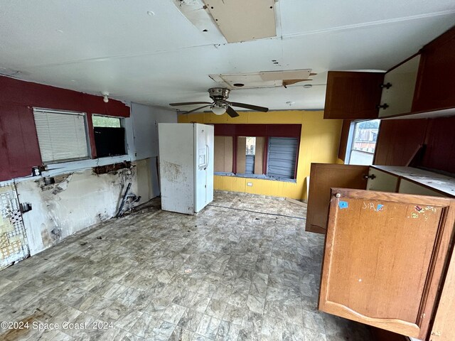 unfurnished living room featuring ceiling fan