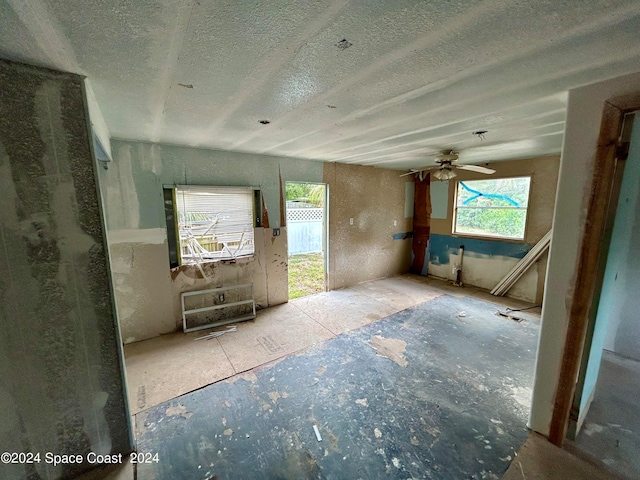 interior space featuring a textured ceiling and ceiling fan