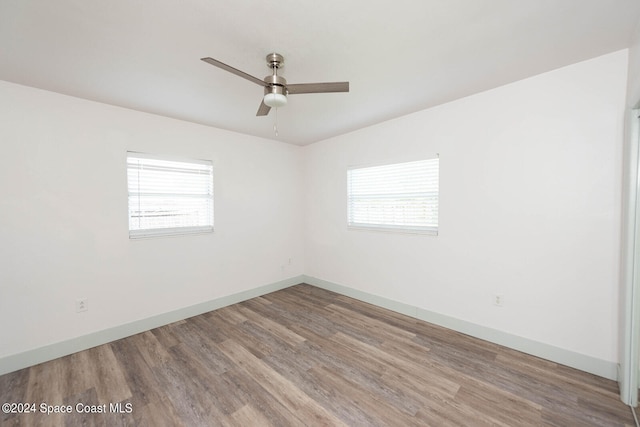 empty room featuring ceiling fan, light hardwood / wood-style floors, and plenty of natural light