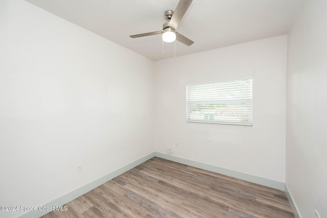 empty room with light hardwood / wood-style floors and ceiling fan