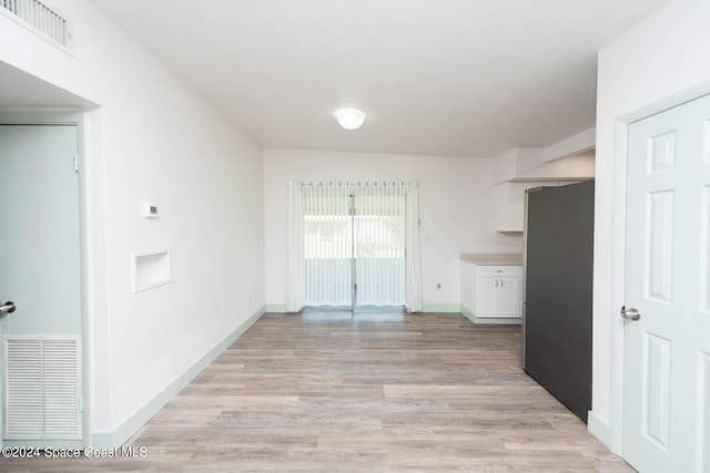 unfurnished dining area with light hardwood / wood-style flooring