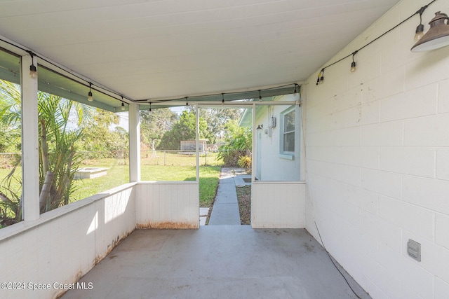 unfurnished sunroom with vaulted ceiling