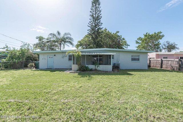 back of house with a lawn