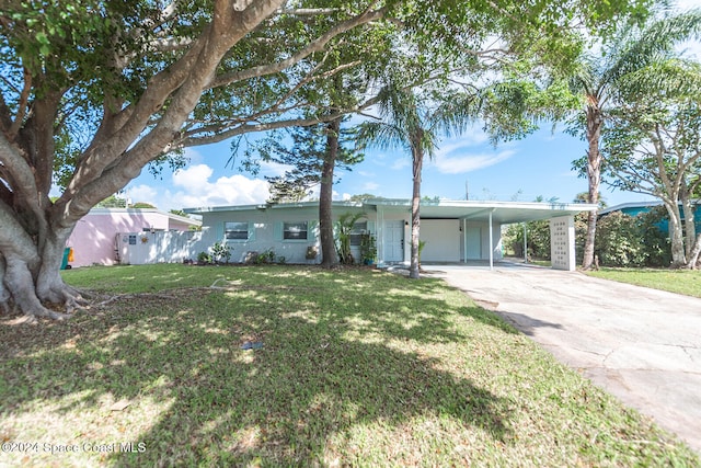 ranch-style house featuring a front yard and a carport