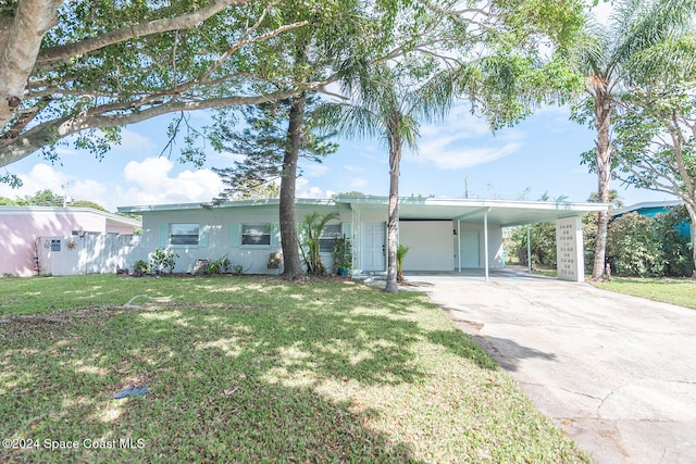 ranch-style house featuring a carport and a front lawn