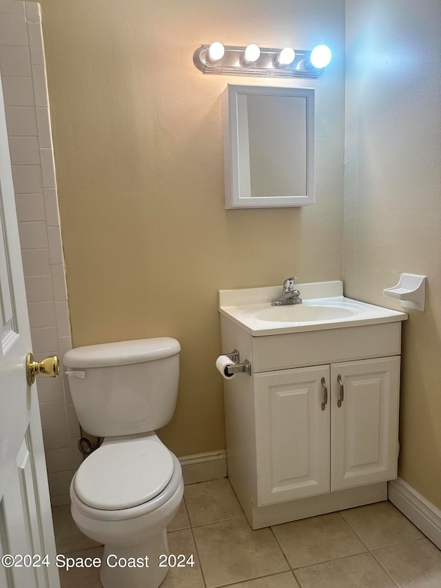 bathroom featuring tile patterned floors, toilet, and vanity