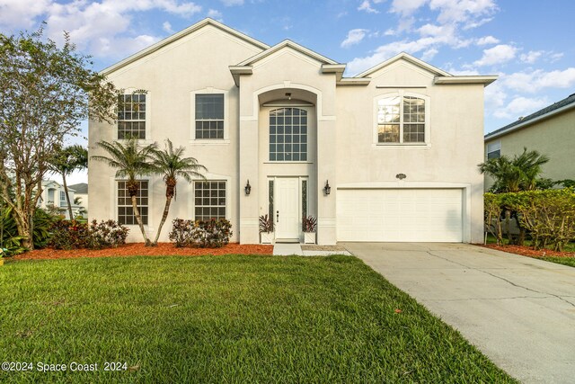 view of front facade with a front lawn and a garage