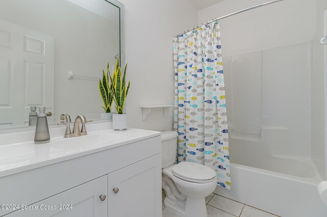 full bathroom with shower / tub combo, tile patterned flooring, vanity, and toilet