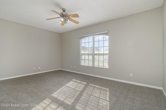 unfurnished room featuring ceiling fan and carpet floors