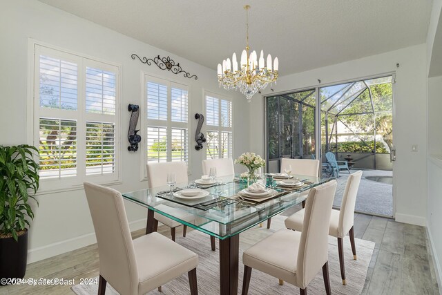 dining area with a chandelier and light hardwood / wood-style floors