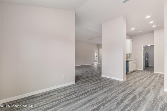 unfurnished living room with water heater and light hardwood / wood-style flooring