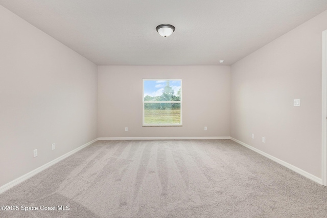 unfurnished room with light colored carpet