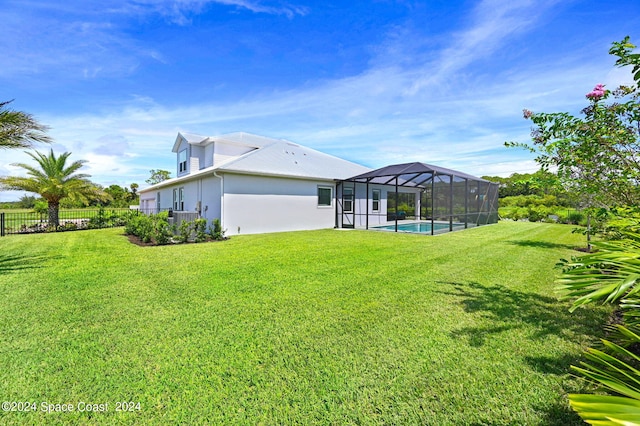 view of yard with glass enclosure and a fenced in pool