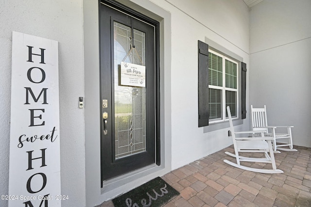 view of exterior entry with a porch