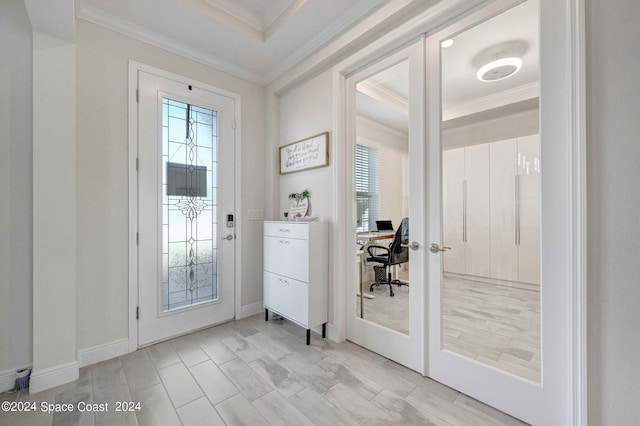 doorway with a raised ceiling and crown molding