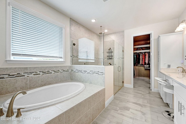 bathroom with plus walk in shower and vanity