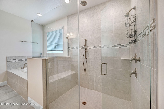 bathroom featuring wood-type flooring and independent shower and bath