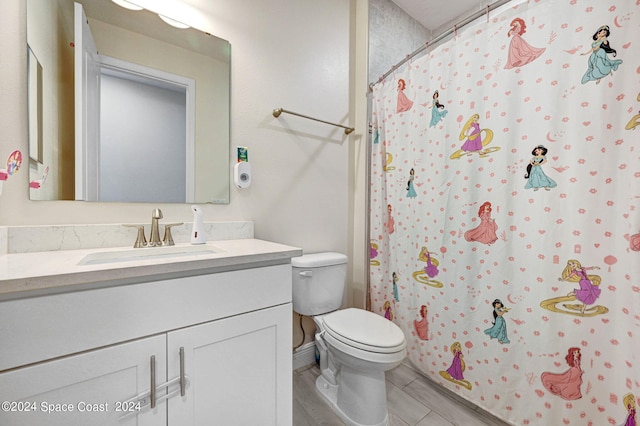 bathroom featuring hardwood / wood-style floors, vanity, and toilet