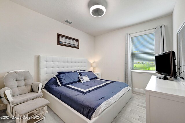 bedroom with light hardwood / wood-style floors