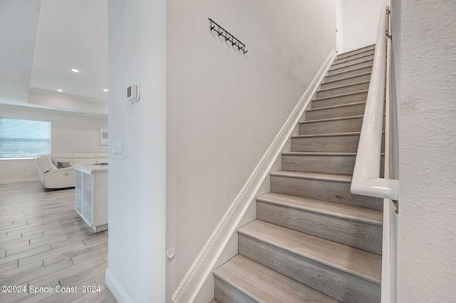 stairs featuring hardwood / wood-style flooring