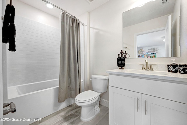 full bathroom featuring shower / bathtub combination with curtain, vanity, hardwood / wood-style floors, and toilet