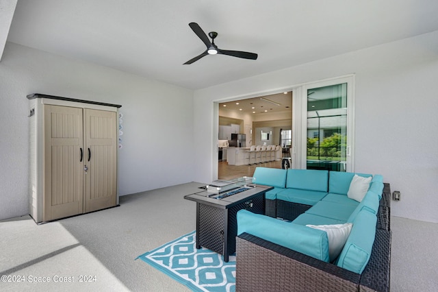 view of patio with an outdoor living space and ceiling fan