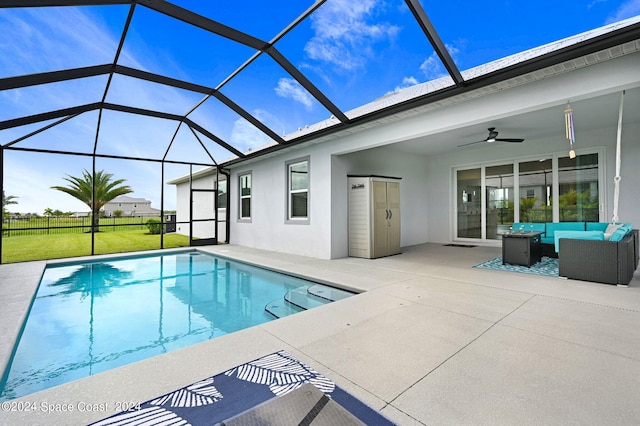 view of swimming pool featuring outdoor lounge area, a lanai, a patio area, and ceiling fan