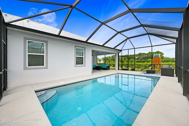 view of swimming pool with glass enclosure and a patio area