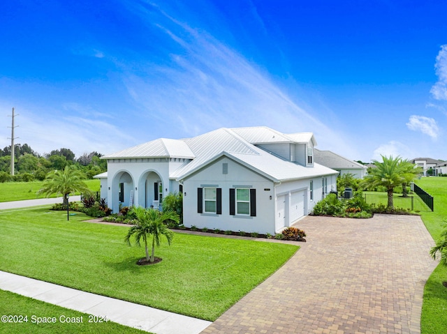 view of front of property featuring a garage and a front yard