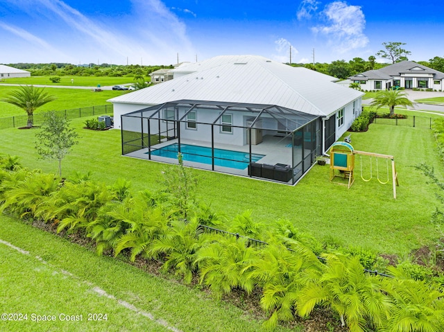 back of property featuring a lawn and glass enclosure