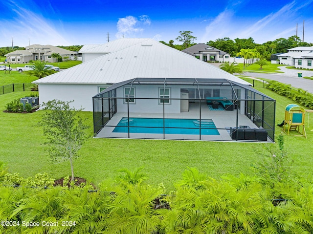 rear view of property featuring a lanai, a patio area, and a yard