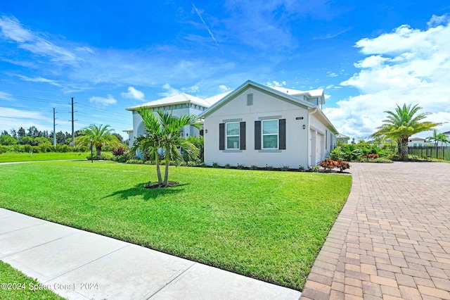 view of front of property with a garage and a front lawn