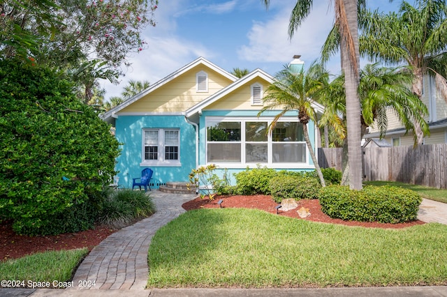 bungalow-style house with a front yard