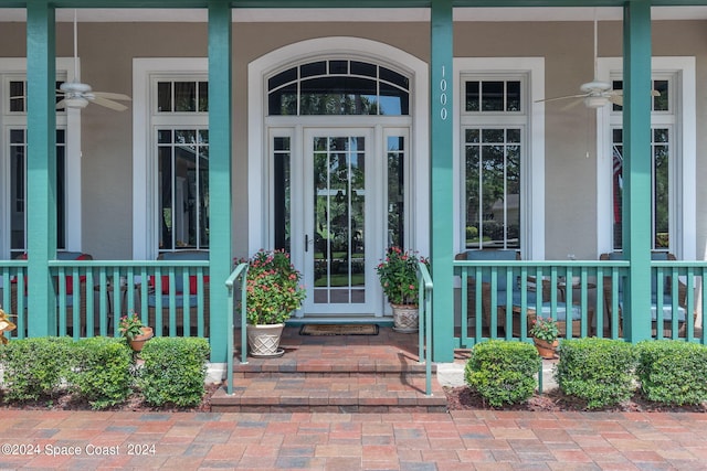 entrance to property with a porch and ceiling fan