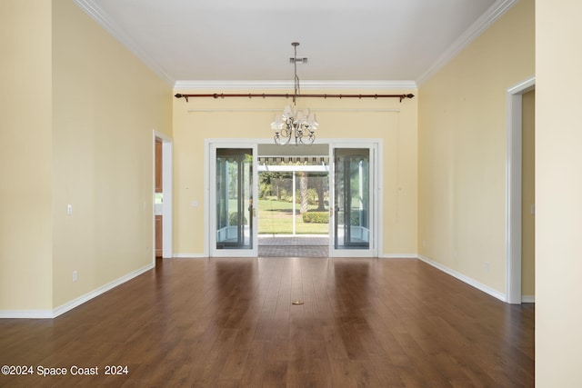 unfurnished room featuring a notable chandelier, dark hardwood / wood-style floors, and crown molding