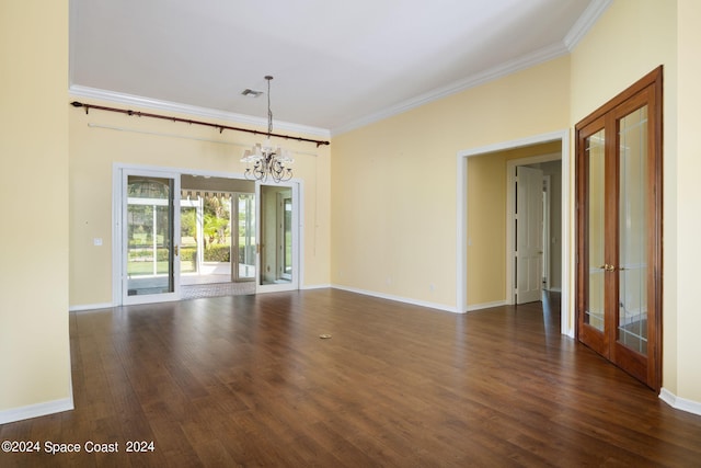 empty room featuring french doors, an inviting chandelier, dark hardwood / wood-style floors, and ornamental molding