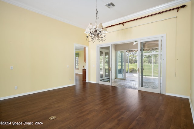 unfurnished room featuring an inviting chandelier, dark hardwood / wood-style floors, and crown molding