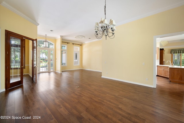 unfurnished room with an inviting chandelier, crown molding, dark hardwood / wood-style floors, and sink