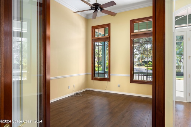 unfurnished room featuring ceiling fan, crown molding, and dark wood-type flooring