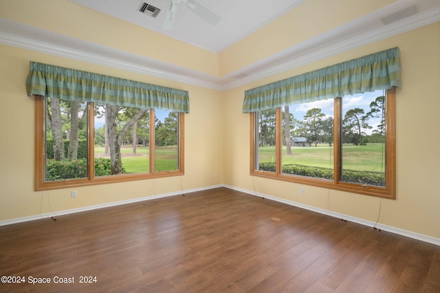 unfurnished room featuring ornamental molding, ceiling fan, and dark wood-type flooring