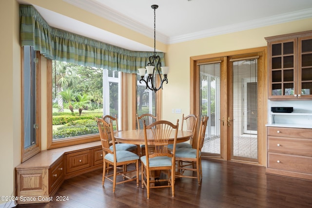 dining area featuring an inviting chandelier, crown molding, and dark wood-type flooring