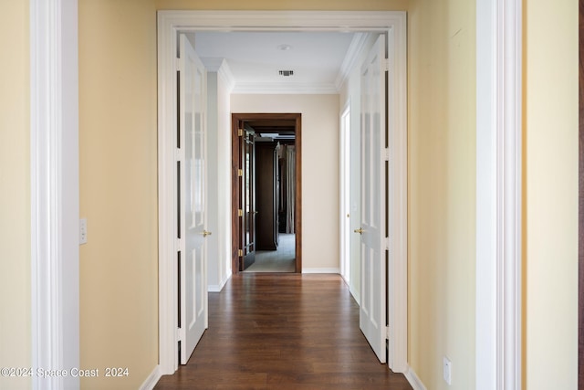 hall featuring crown molding and dark wood-type flooring