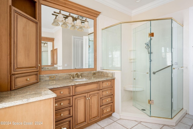 bathroom featuring vanity, crown molding, a shower with door, and tile patterned floors