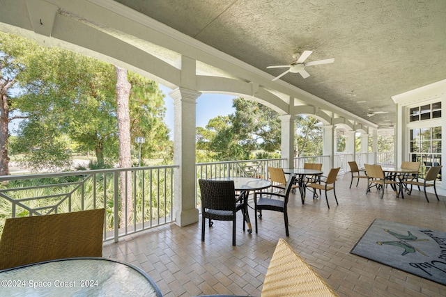 sunroom featuring ceiling fan and plenty of natural light